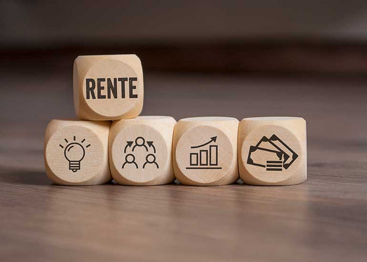 Aufeinander gestapelte Holzwürfel mit dem Wort „RENTE“ und Symbolen für Innovation, Zusammenarbeit, Wertentwicklung und Finanzen.